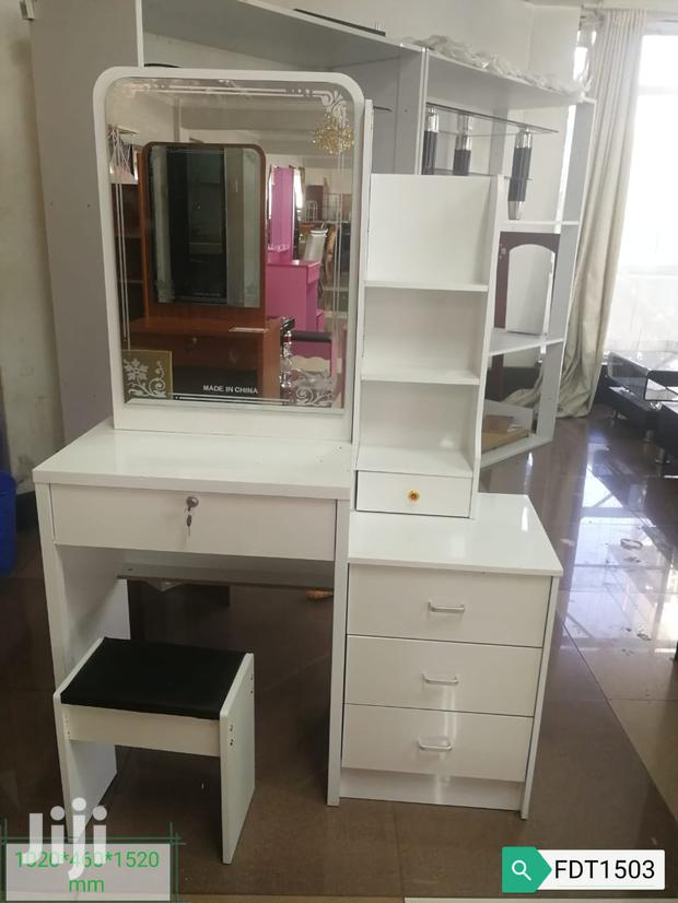 White Dresser With a Sliding Mirror