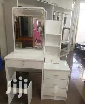 White Dresser With a Sliding Mirror
