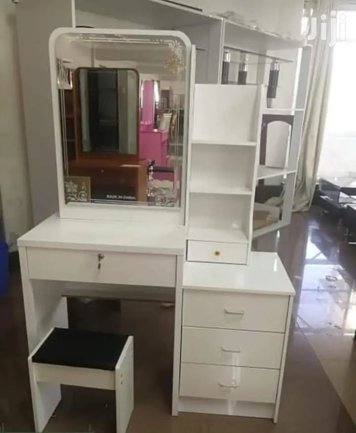 White Dresser With a Sliding Mirror