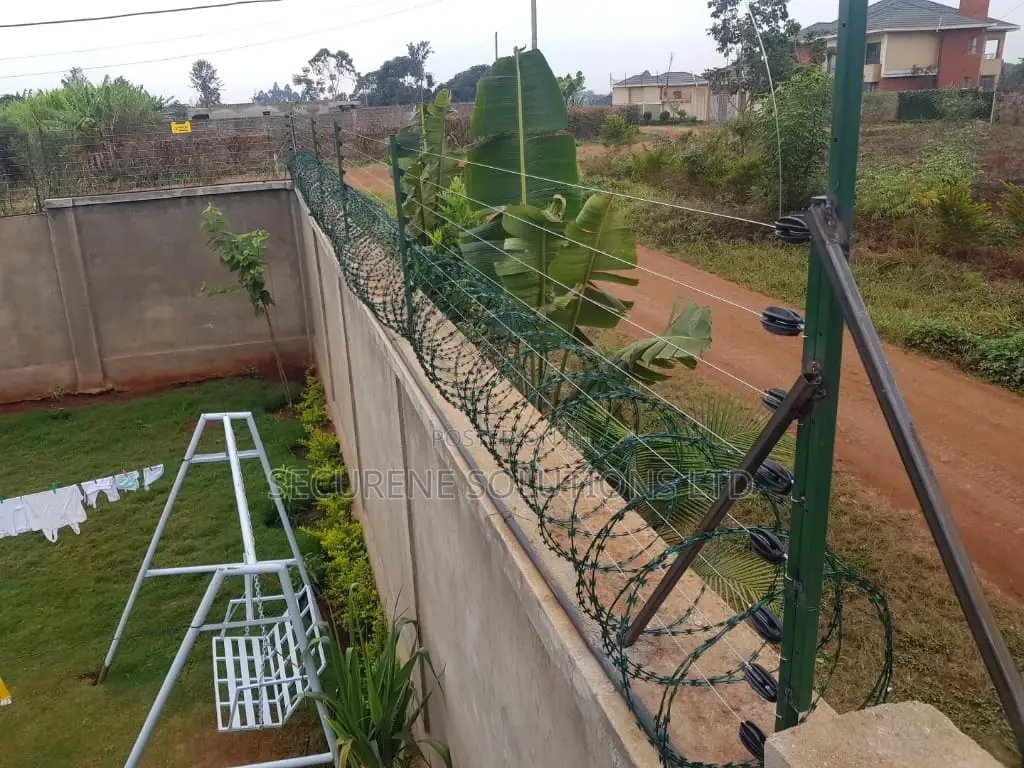 Wall Mount Electric Fencing With Green Razor Wire