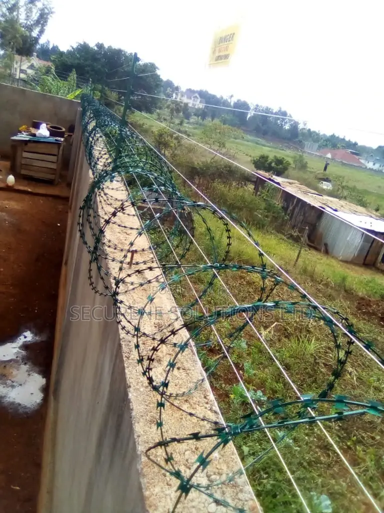 Wall Mount Electric Fencing With Green Razor Wire