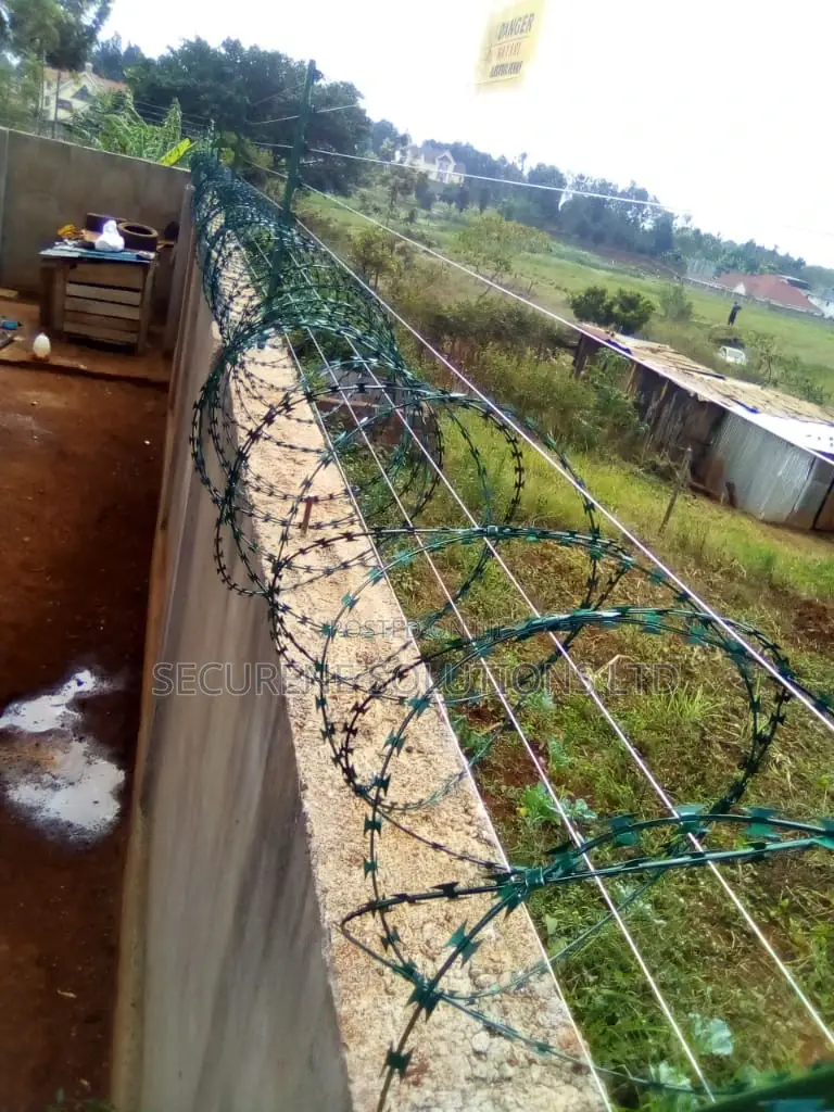 Wall Mount Electric Fencing With Green Razor Wire