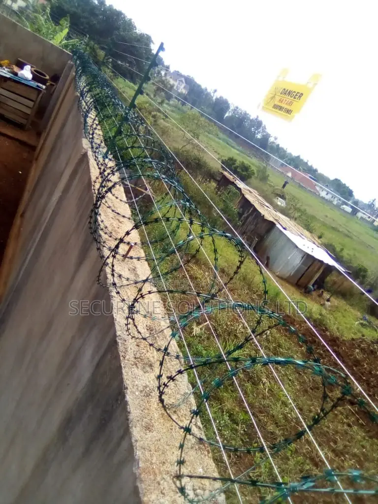 Wall Mount Electric Fencing With Green Razor Wire