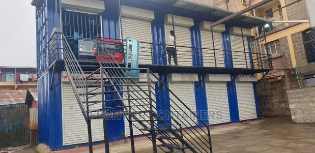 Container Shops Stacked With Staircase and Balcony