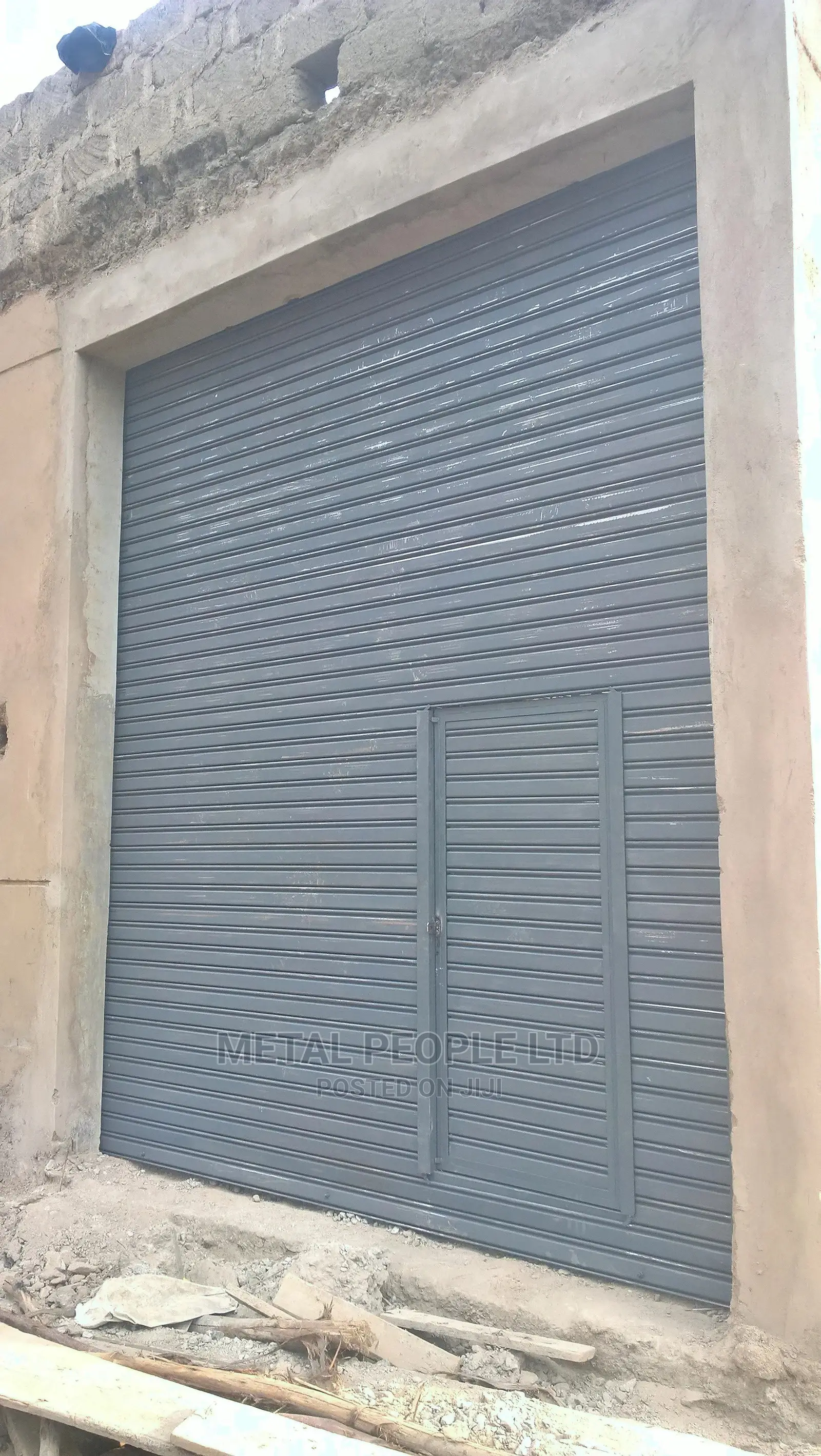 Roller Shutter Doors for Sale. Option of a Small Side Door.