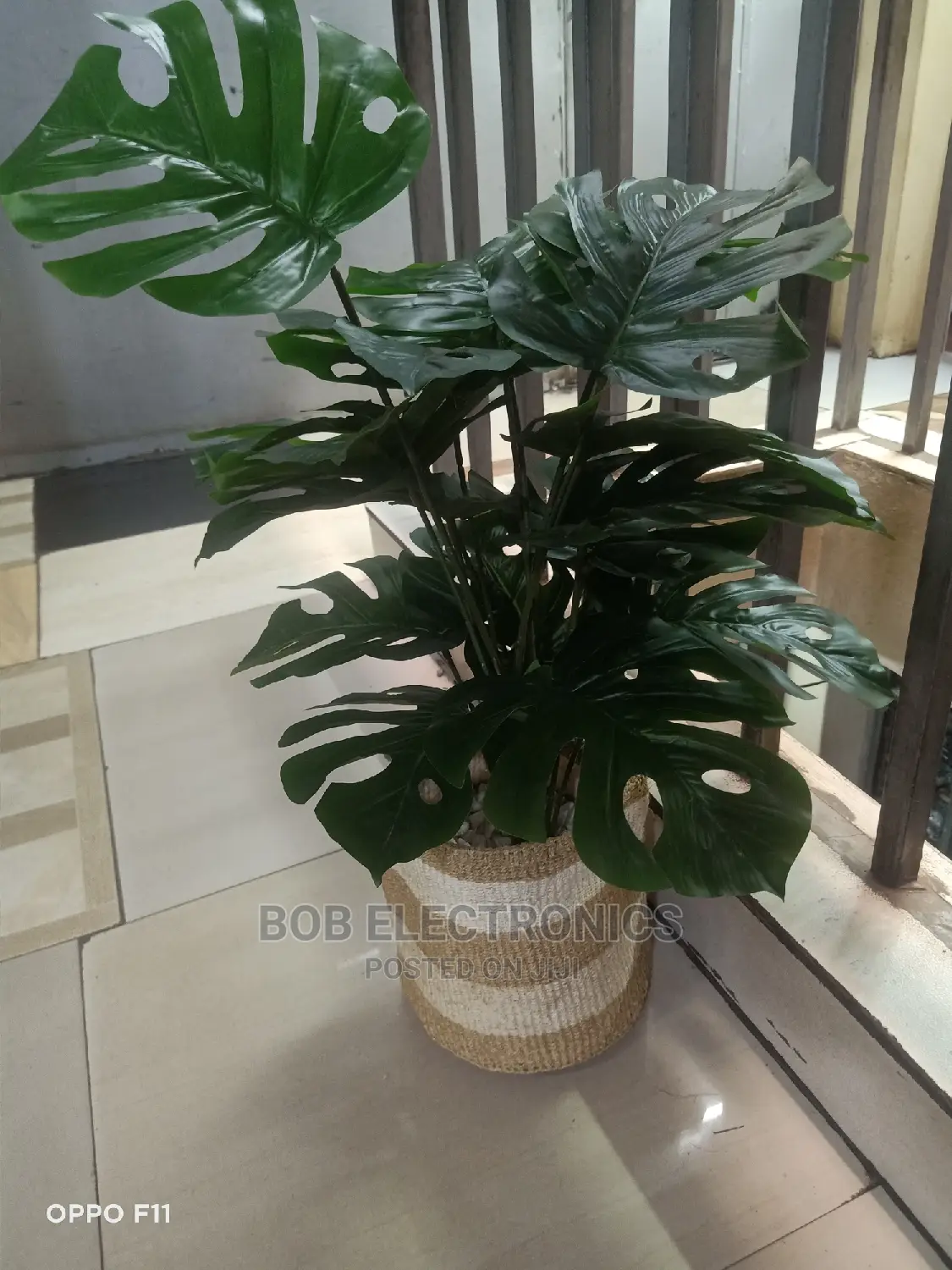 Artificial Monstera Plant With Woven Basket and Pebbles