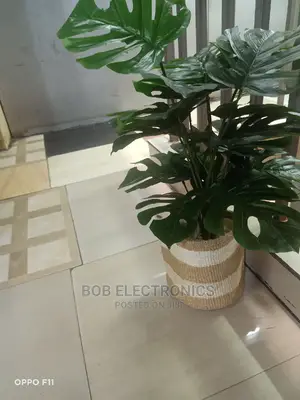 Artificial Monstera Plant With Woven Basket and Pebbles