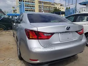 Luxury hybrid sedan with premium features and unparalleled performance, available in silver.