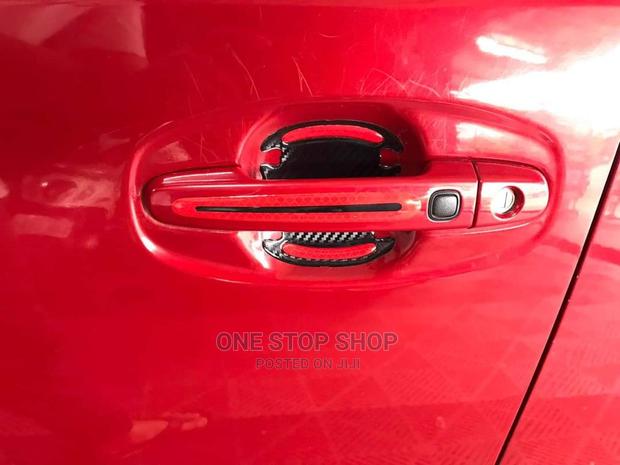 Red Car Fitted With Door Handle Antiscratch Stickers - main view