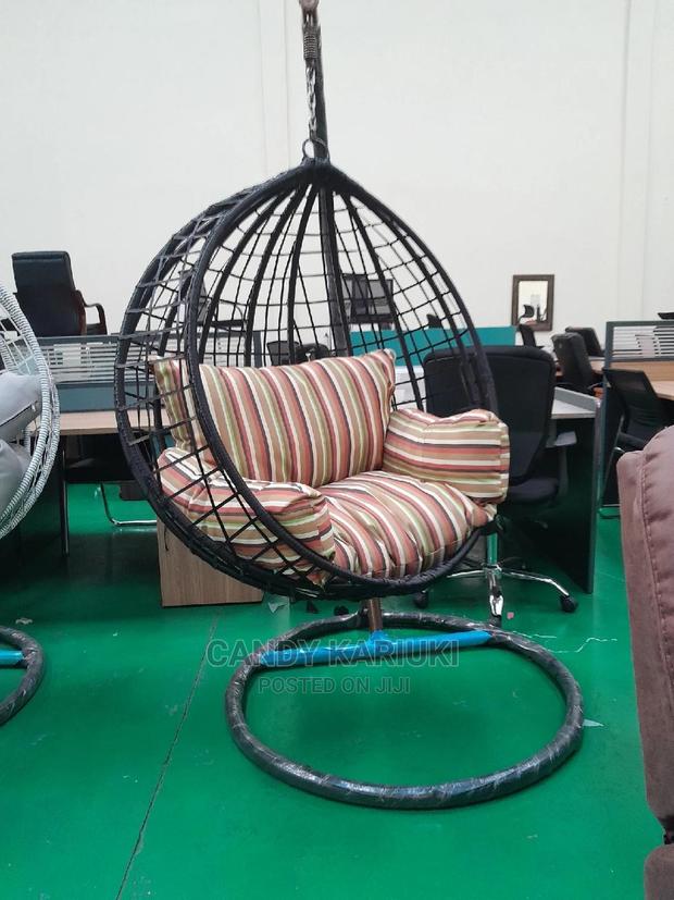 Outdoor Swing With Striped Cushions