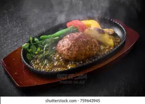 Cast Iron Hot Sizzling Plate On Wooden Tray