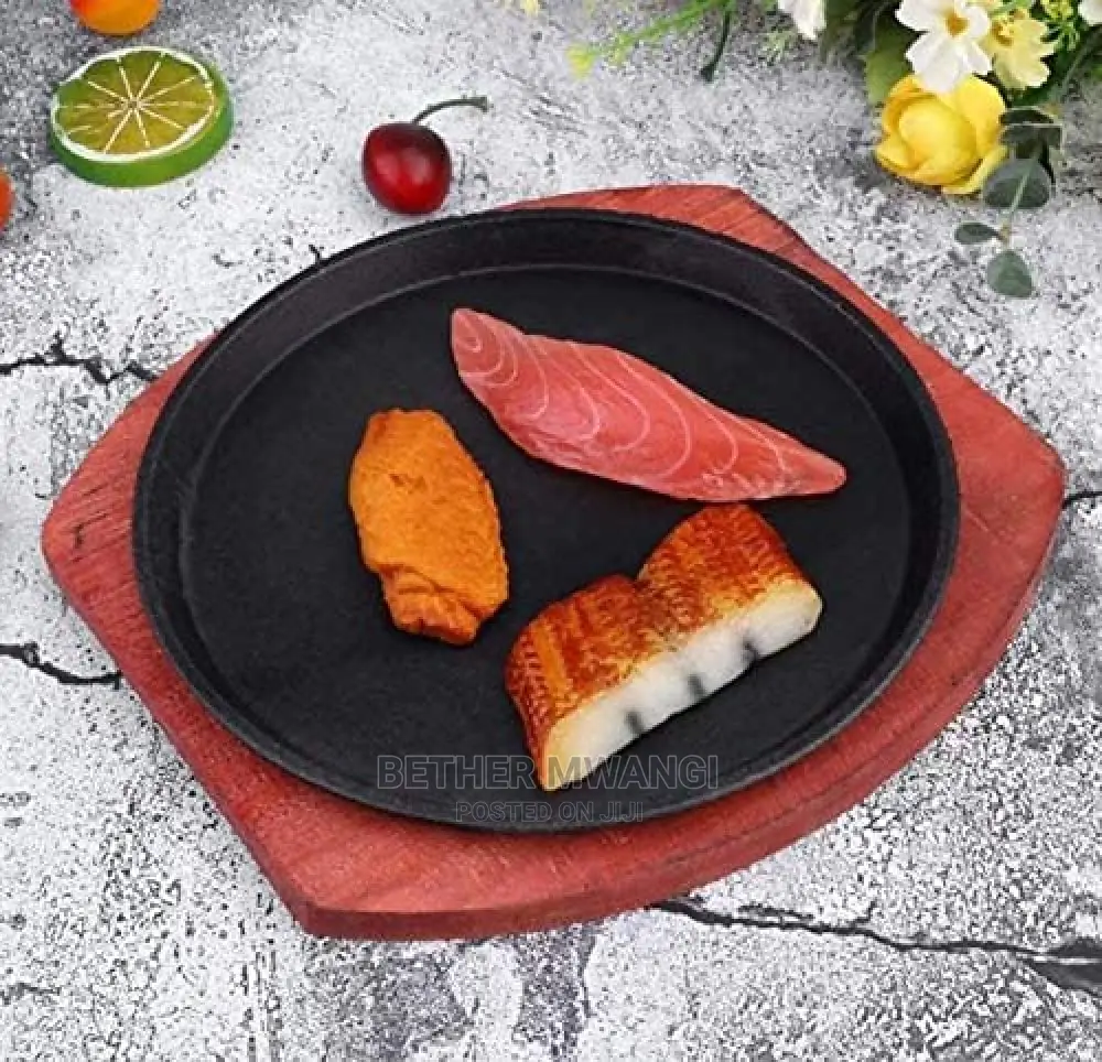 Cast-Iron Hot Sizzling Plate on Wooden Tray in Kenya