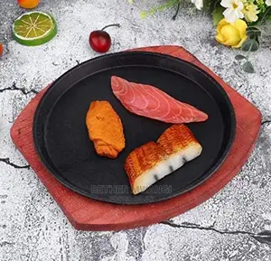 Cast-Iron Hot Sizzling Plate on Wooden Tray in Kenya