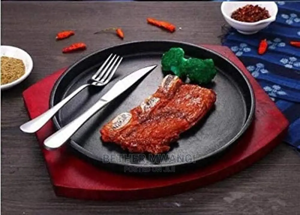 Cast-Iron Hot Sizzling Plate on Wooden Tray in Kenya
