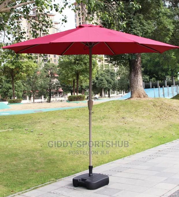 Folding an Outdoor Umbrella With an Iron Pipe - main view