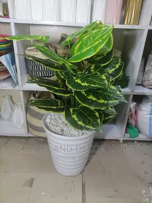 Vase With Artificial Plant and Pebble Stones