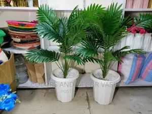 Palm Tree and Plastic Vase With Pebble Stones