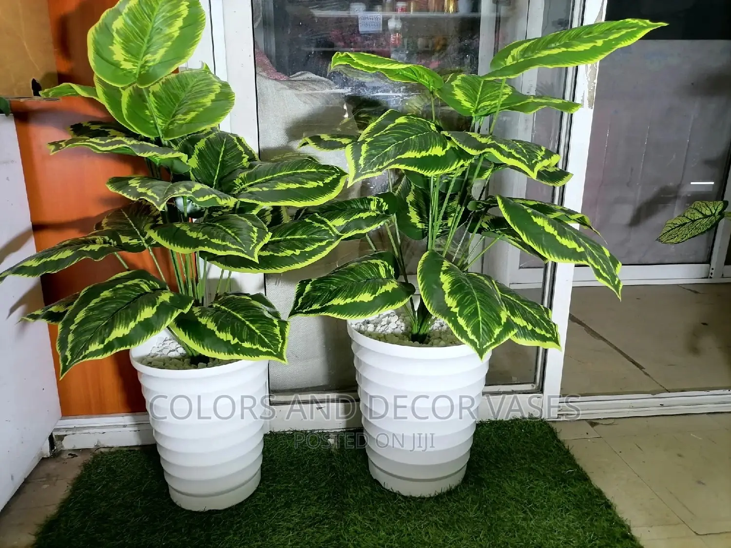 Plastic Vase With Artificial Plant and Stones on Offer