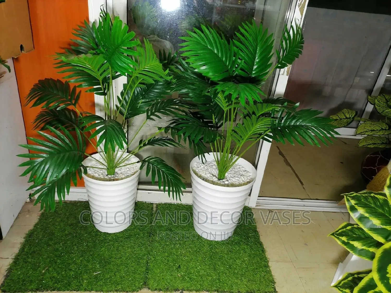 Palm Tree and Plastic Vase With Pebble Stones
