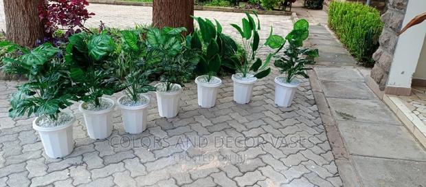 Artificial Plants With Vases and Pebble Stones