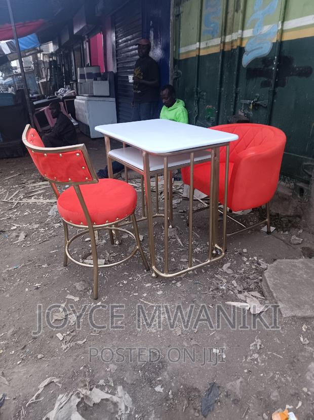 Manicure Set, Orange Seats and Marble Table.