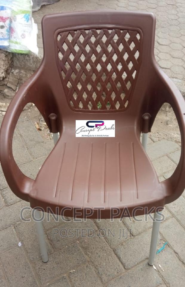 Brown Plastic Chair With Metal Tubing Legs.