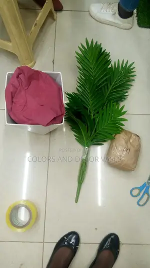 Palm Tree Plastic Vase and Pebble Stones Is on Offer