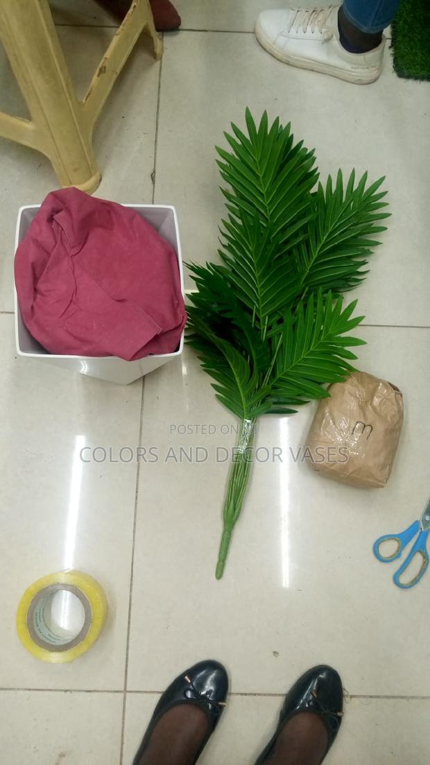 Palm Tree Plastic Vase and Pebble Stones Is on Offer