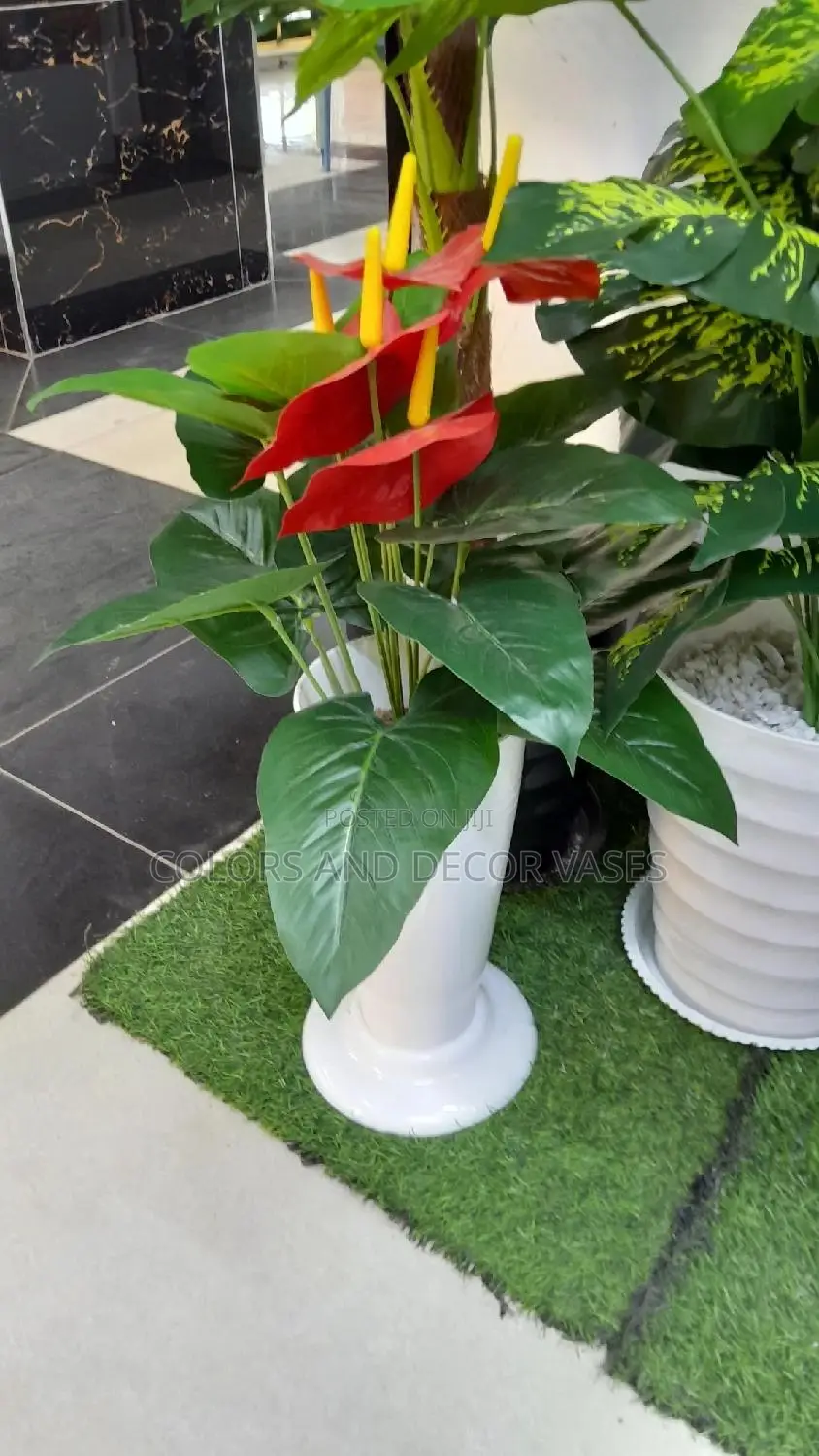 Flowered Plant And Vase With Pebble Stones