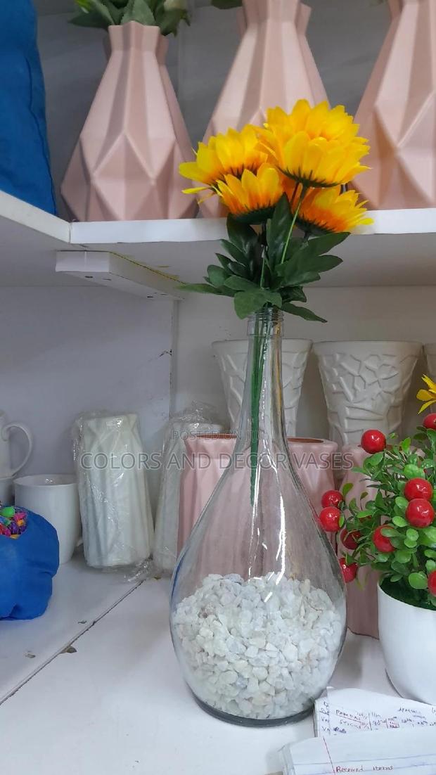 Glass Vase With Flowers and Pebble Stones