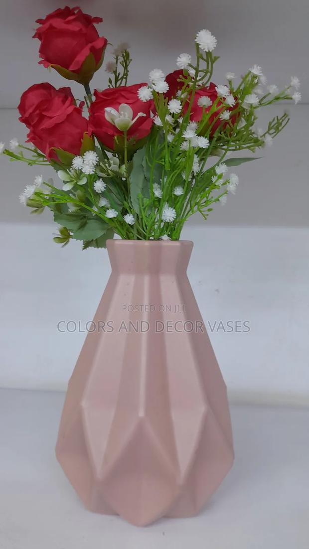 Pink Plastic Vase With Red and White Flowers