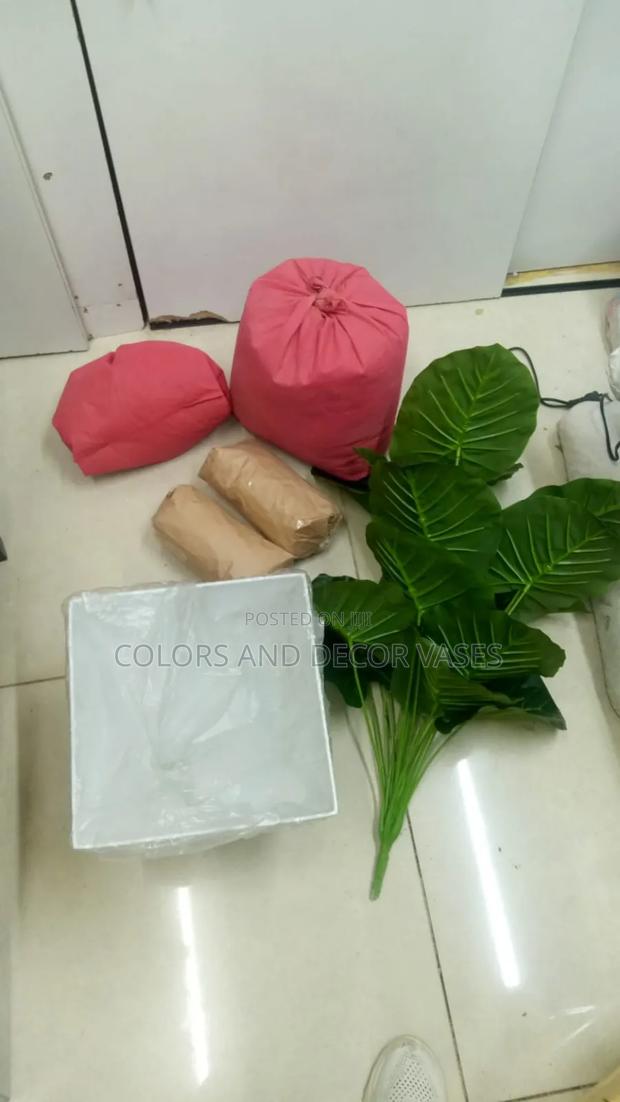 A Set of Artificial Plant, Plastic Vase and White Stones