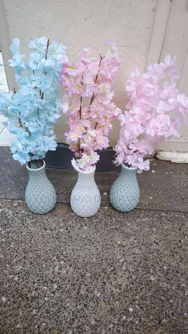 Blossom Flowers With Plastic Vase And Pebble Stones