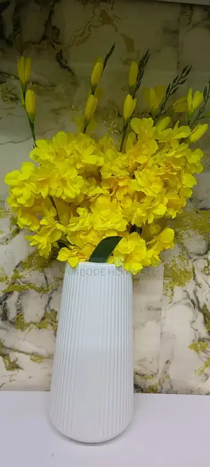 Yellow Flowers With a Large Flower Vase