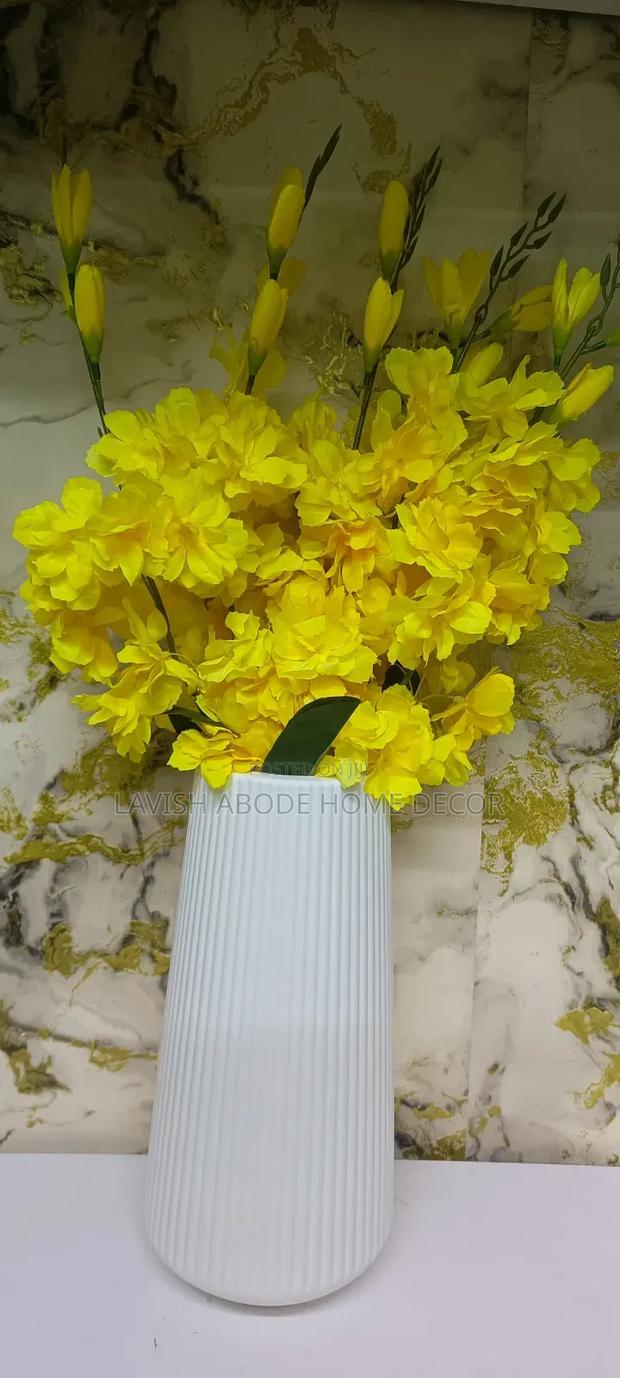 Yellow Flowers With a Large Flower Vase