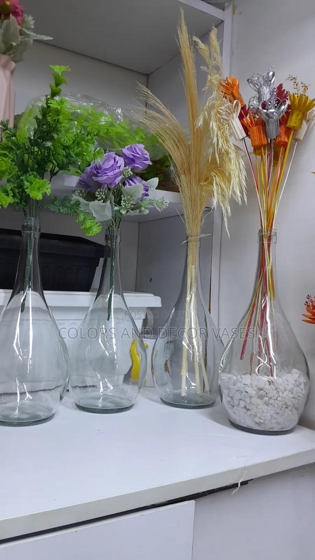 Glass Round Vase With Flowers And Pebble Stones