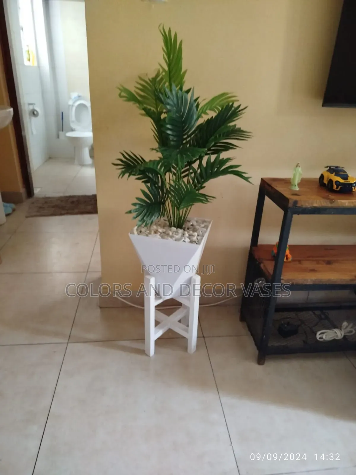 Stand, Plastic Vase and Palm Home Decor Piece