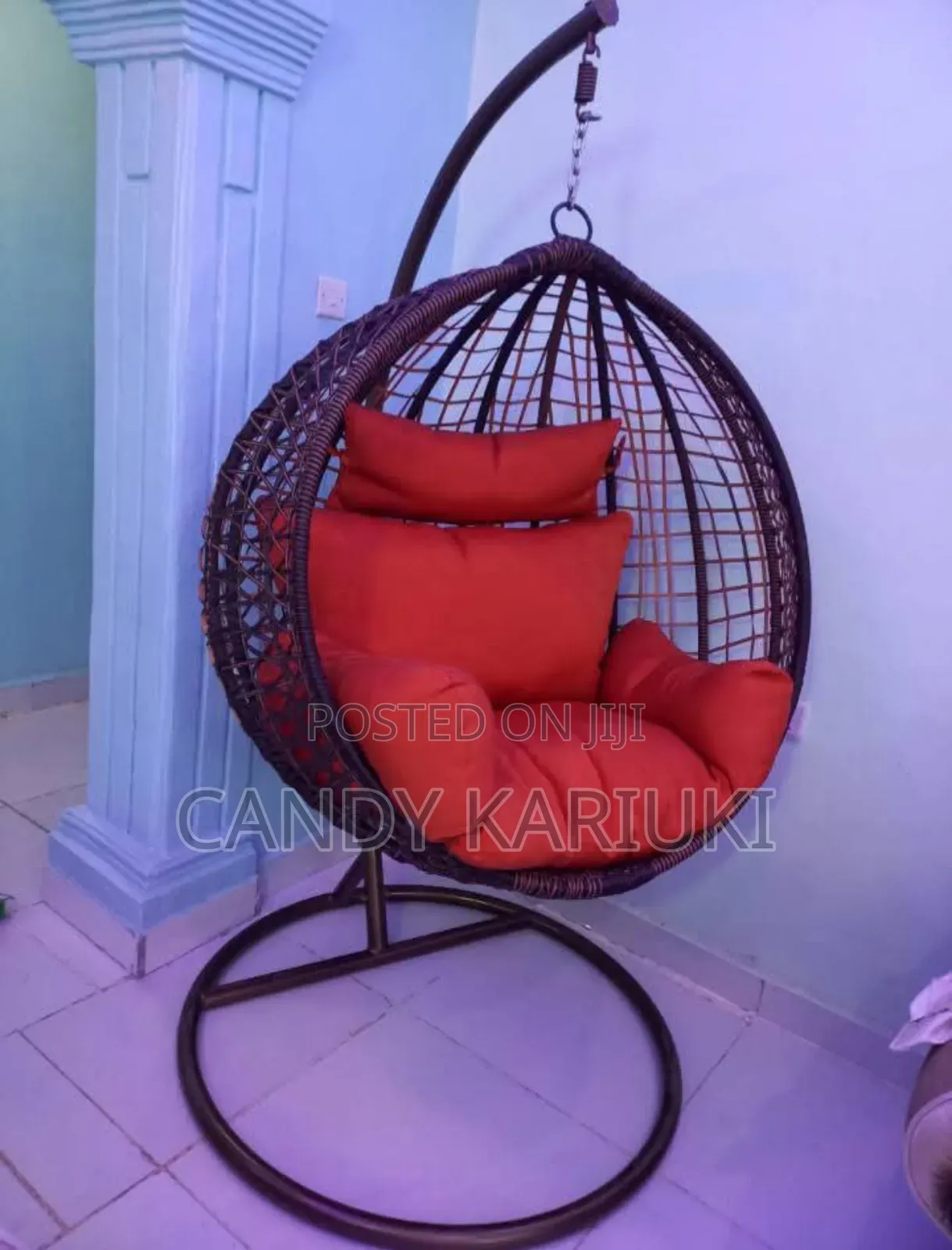 Brown Balcony Swing With Orange Cushions