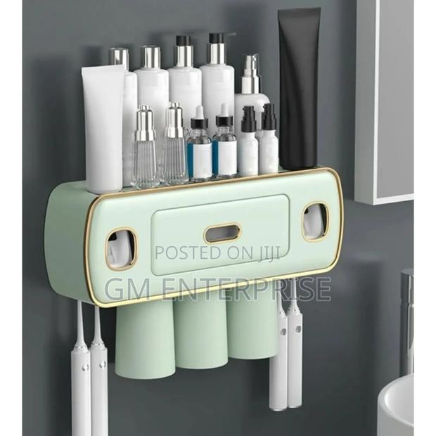 Toothbrush and Toothpaste Holder With Automatic Squeezer
