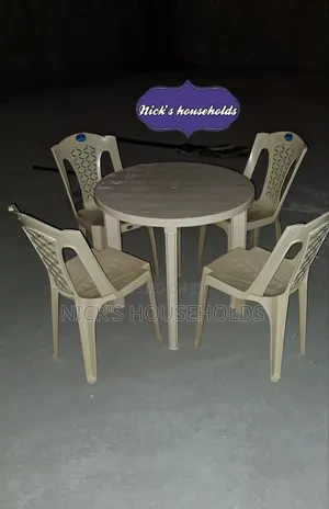 Cream Plastic Chairs With a Round Plastic Table Set