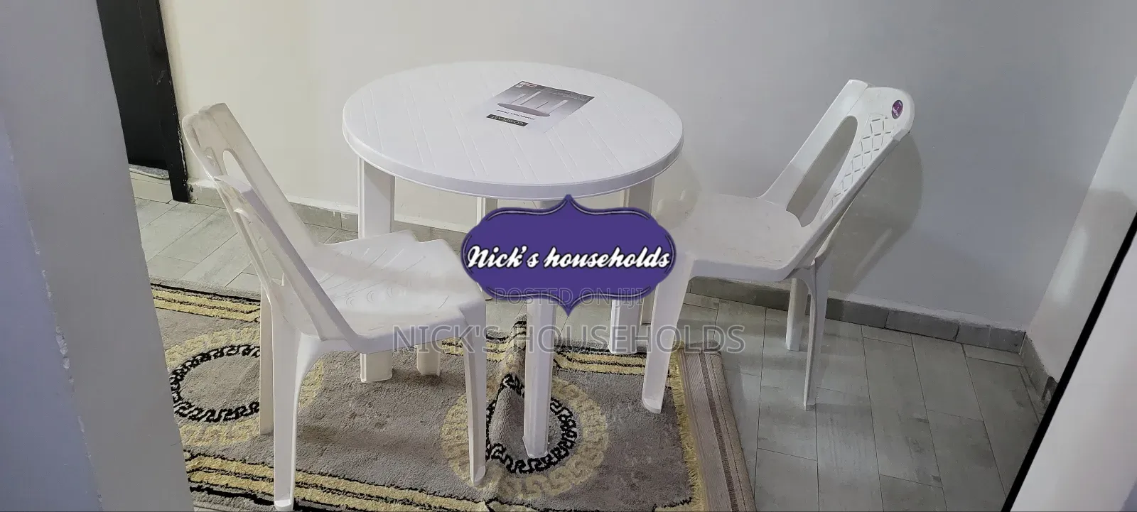 2 Kenpoly Plastic Chairs With a Round Plastic Table