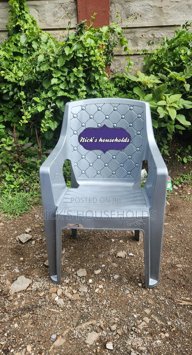 Gray Plastic Chair With High Arms And Pattern Backrest