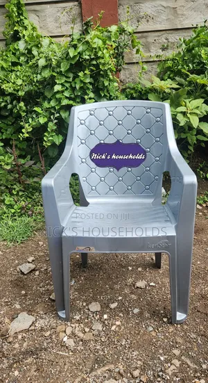 Gray Plastic Chair With High Arms And Pattern Backrest