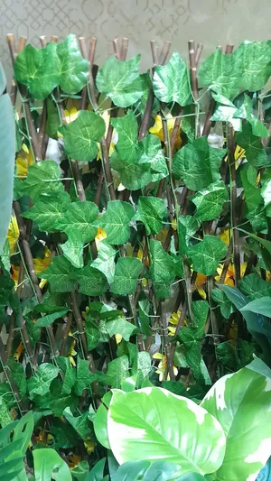 Fence Expanding With Artificial Flowers And And Leaves