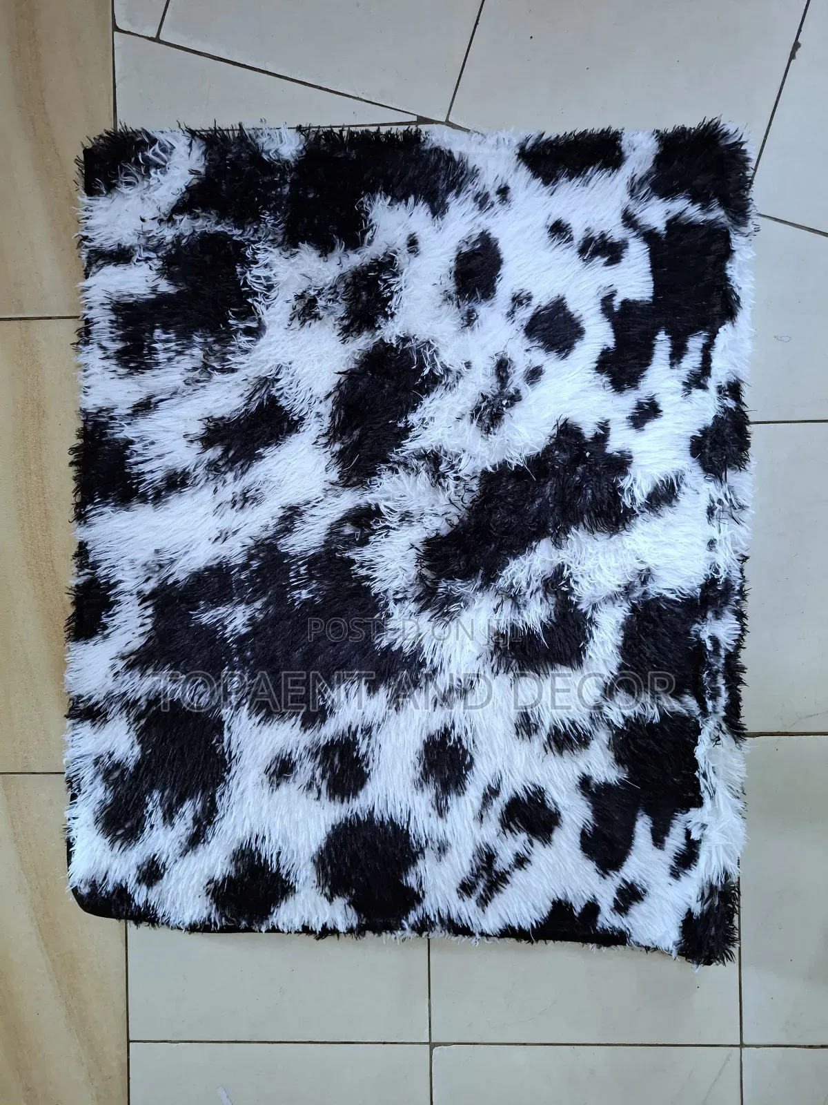 White Fluffy Carpet With Patches of Black
