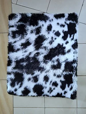 White Fluffy Carpet With Patches of Black