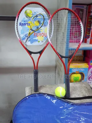 Badminton Racket With One Tennis Ball and a Pair of Racket