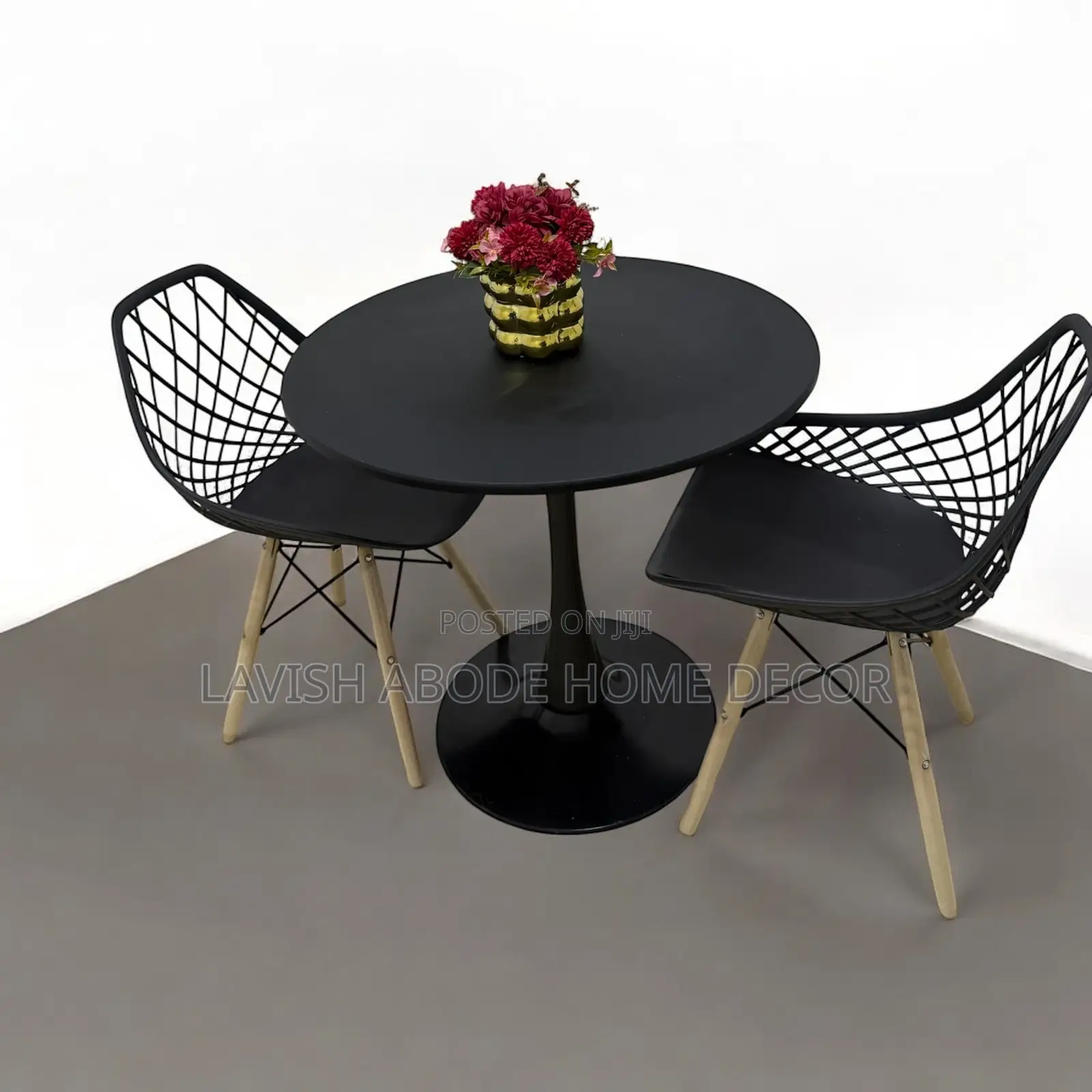 Round Black Tulip Table With 2 Black Mesh Eames Chairs