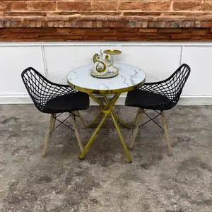 Gold Marble Table With 2 Mesh Eames Chairs