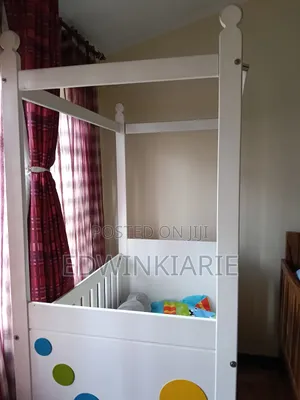 White Baby Crib With Colorful Circle Design
